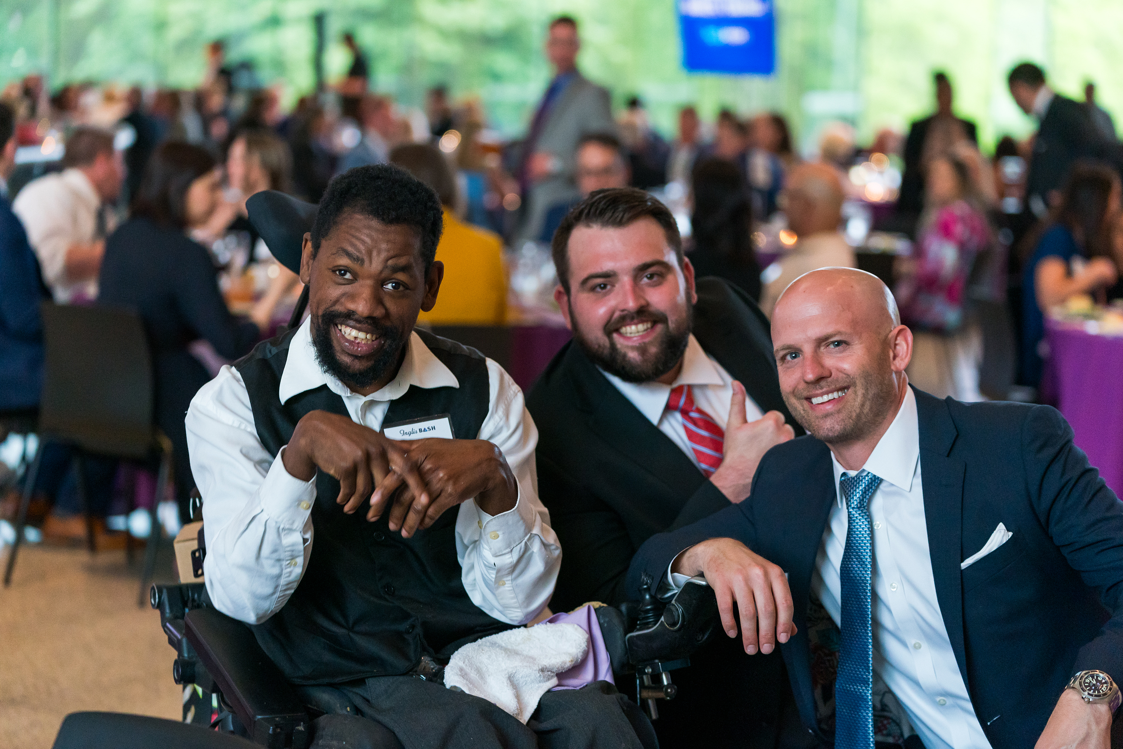 Three attendees of BASH 2024 pose for a photo.