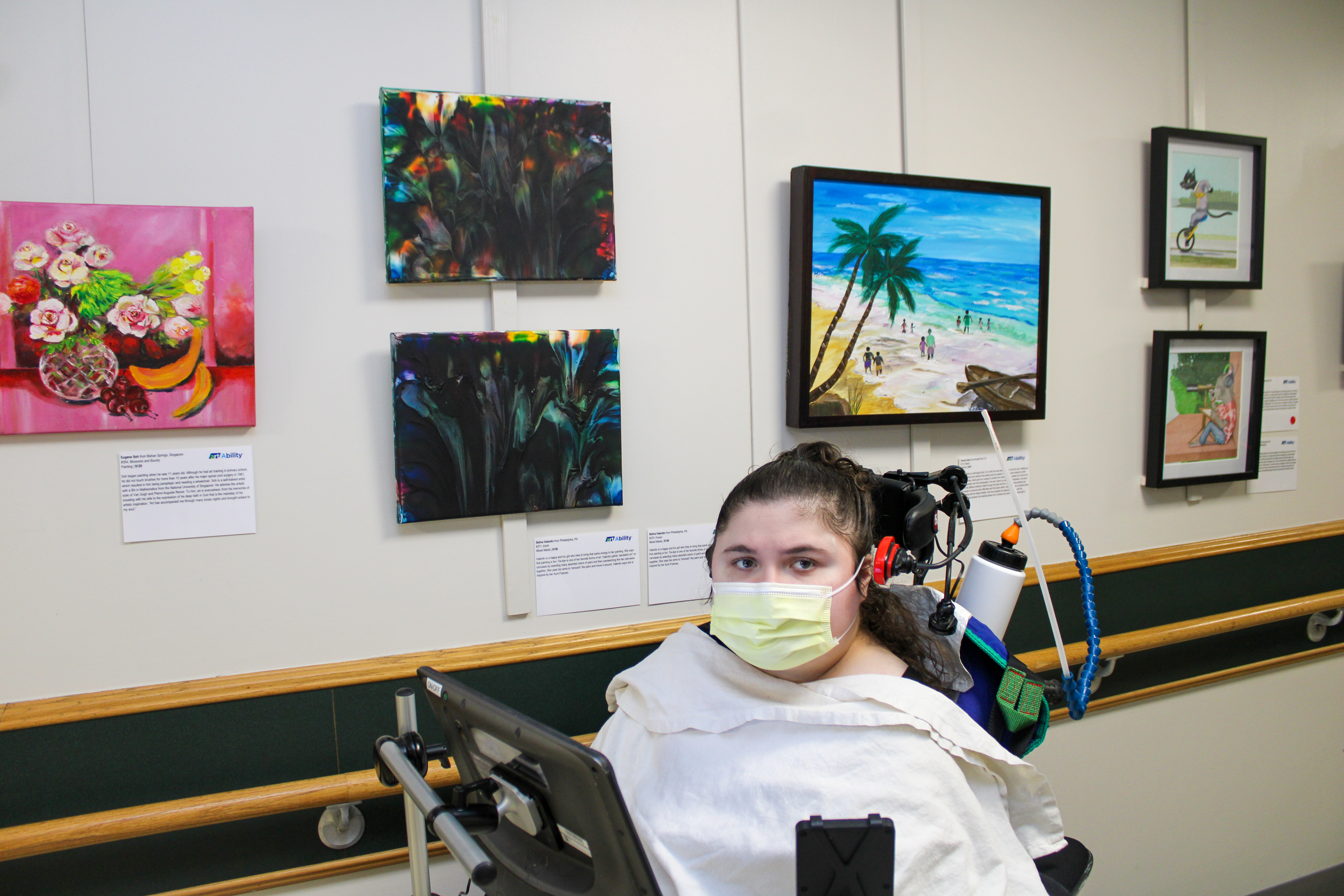 Selina poses in front of some of her artwork